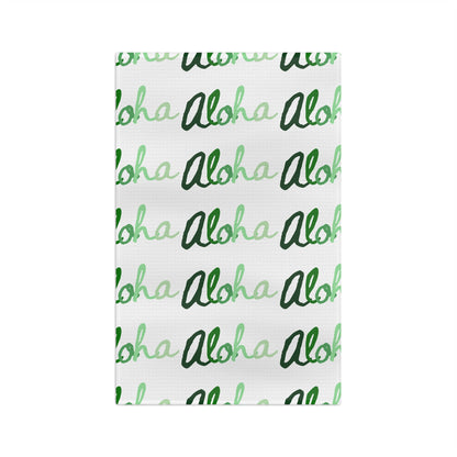 Green Aloha Hawaiʻi kitchen towel with repeating script design in light and dark green on white