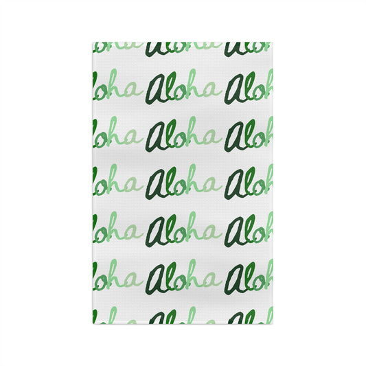 Green Aloha Hawaiʻi kitchen towel with repeating script design in light and dark green on white