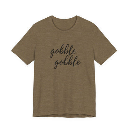 A short-sleeve crewneck t-shirt in heathered olive with the words 'gobble gobble' printed in black script across the chest, shown against a plain white background.