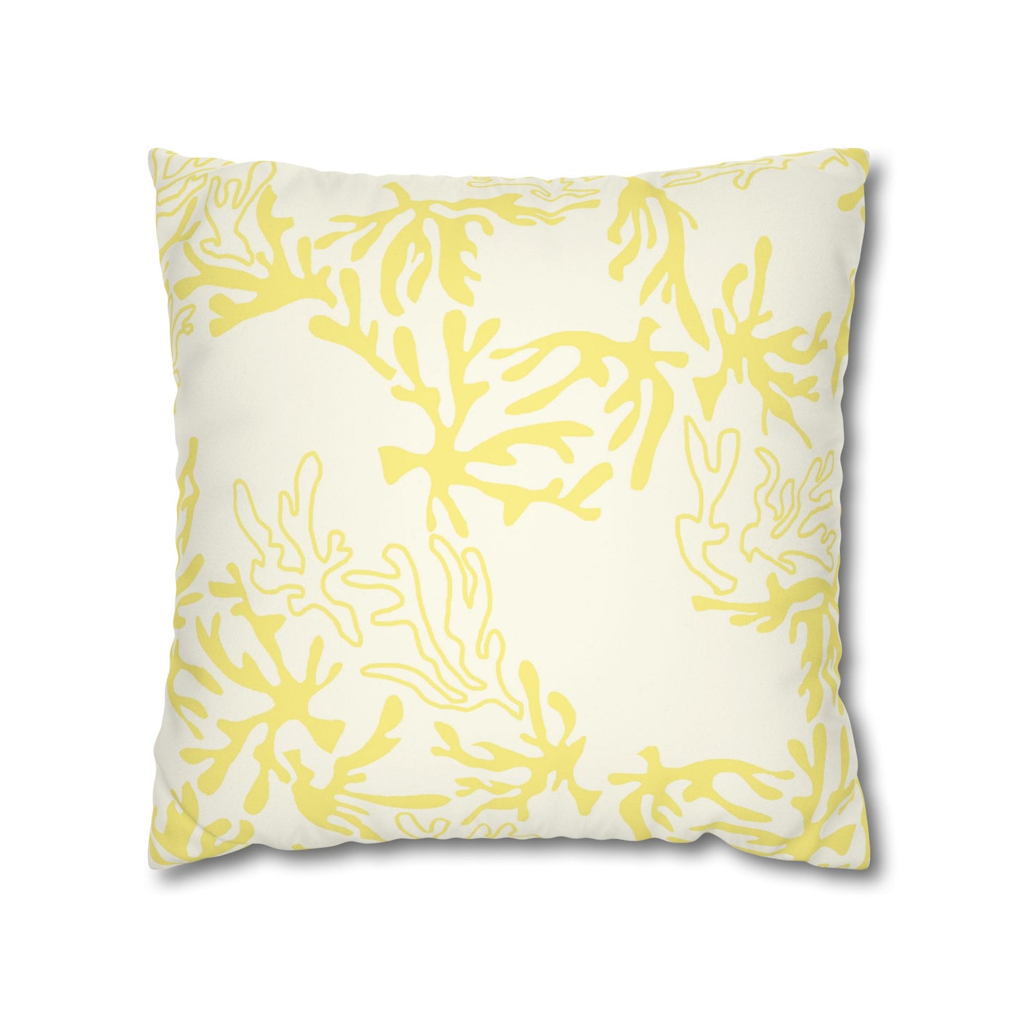 A square throw pillow featuring a yellow coral or seaweed-like abstract pattern on an off-white background, shown against a plain white studio backdrop.