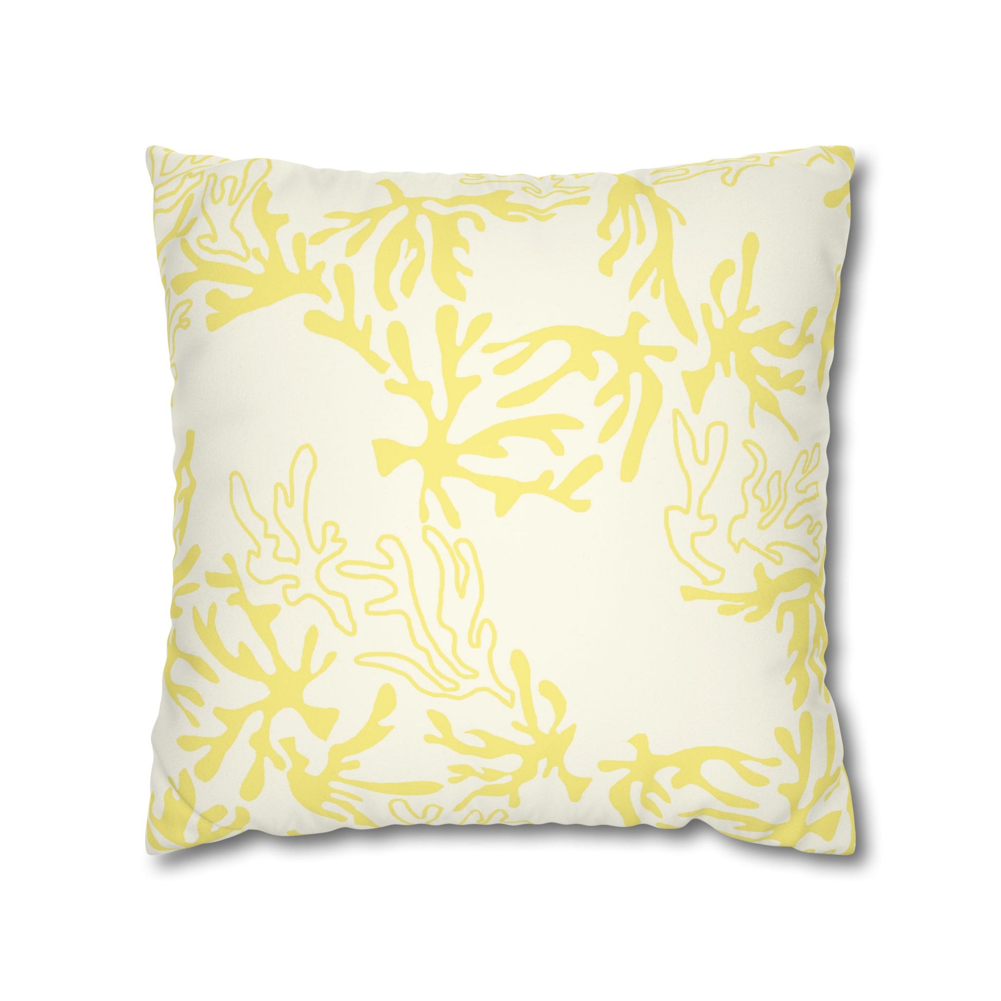 A square throw pillow featuring a yellow coral or seaweed-like abstract pattern on an off-white background, shown against a plain white studio backdrop.