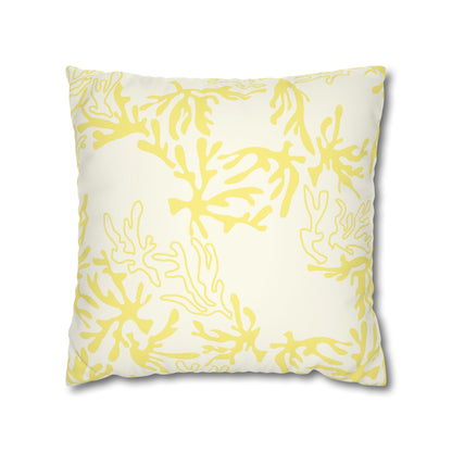 A square throw pillow featuring a yellow coral or seaweed-like abstract pattern on an off-white background, shown against a plain white studio backdrop.
