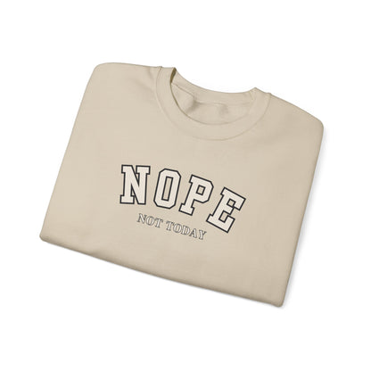 A folded sand crewneck sweatshirt with the words 'NOPE NOT TODAY' printed on the front.