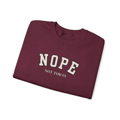 A folded maroon crewneck sweatshirt with 'NOPE NOT TODAY' printed in white varsity-style lettering on the front, shown on a clean white background.