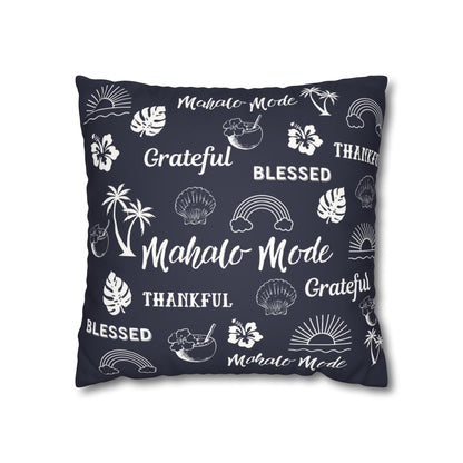 A square throw pillow in dark navy blue with a white tropical-themed print featuring palm trees, hibiscus flowers, seashells, rainbows, and words like 'Mahalo Mode', 'Grateful', and 'Blessed'.