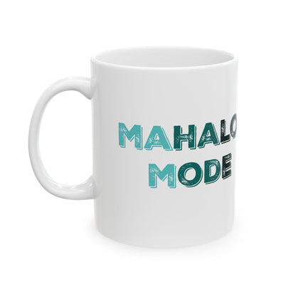 A white ceramic mug with the text 'MAHALO MODE' printed on the side in a distressed teal and black font, shown against a plain white background.