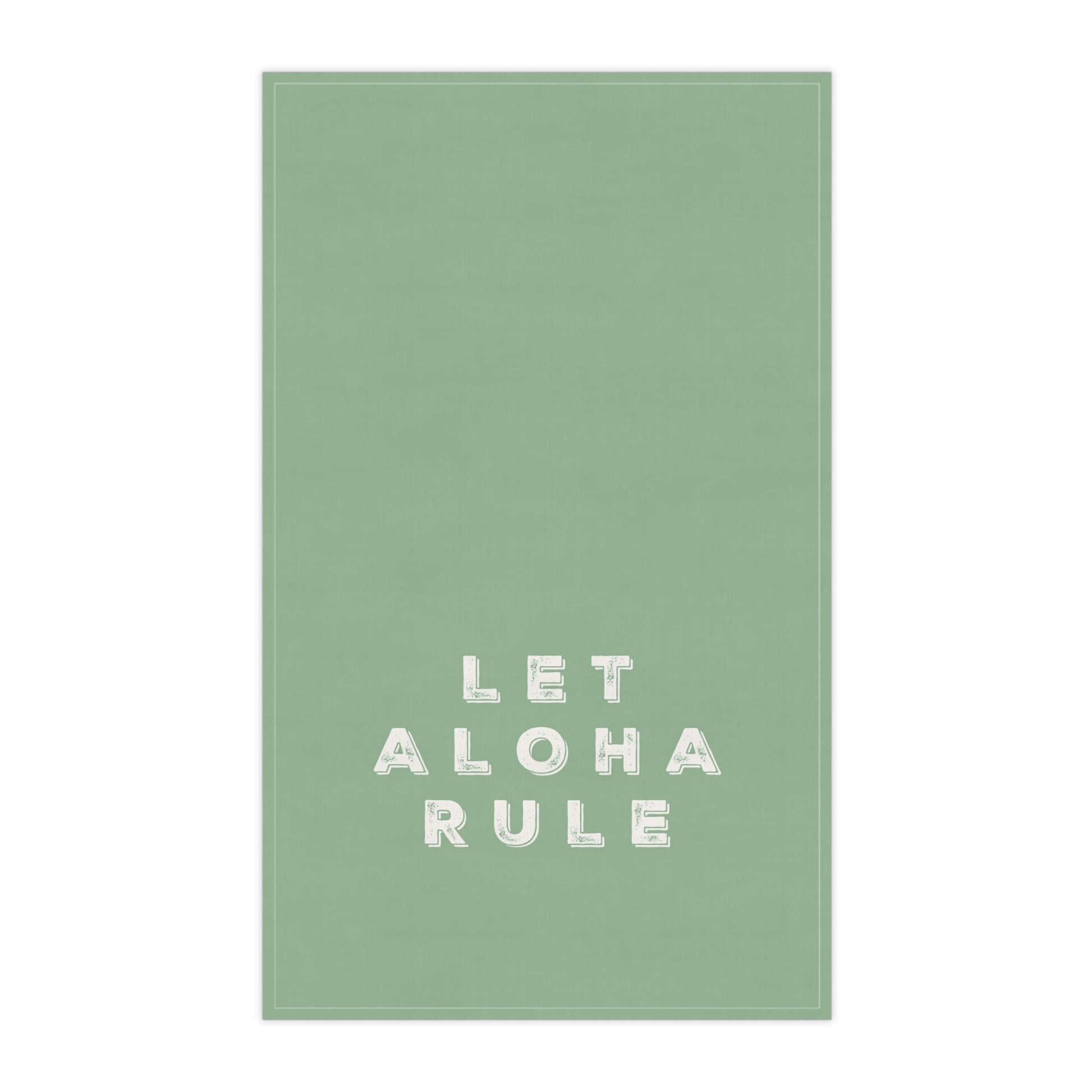 A rectangular sage green tea towel with the phrase 'LET ALOHA RULE' printed in white block letters near the bottom center, shown against a plain white background.