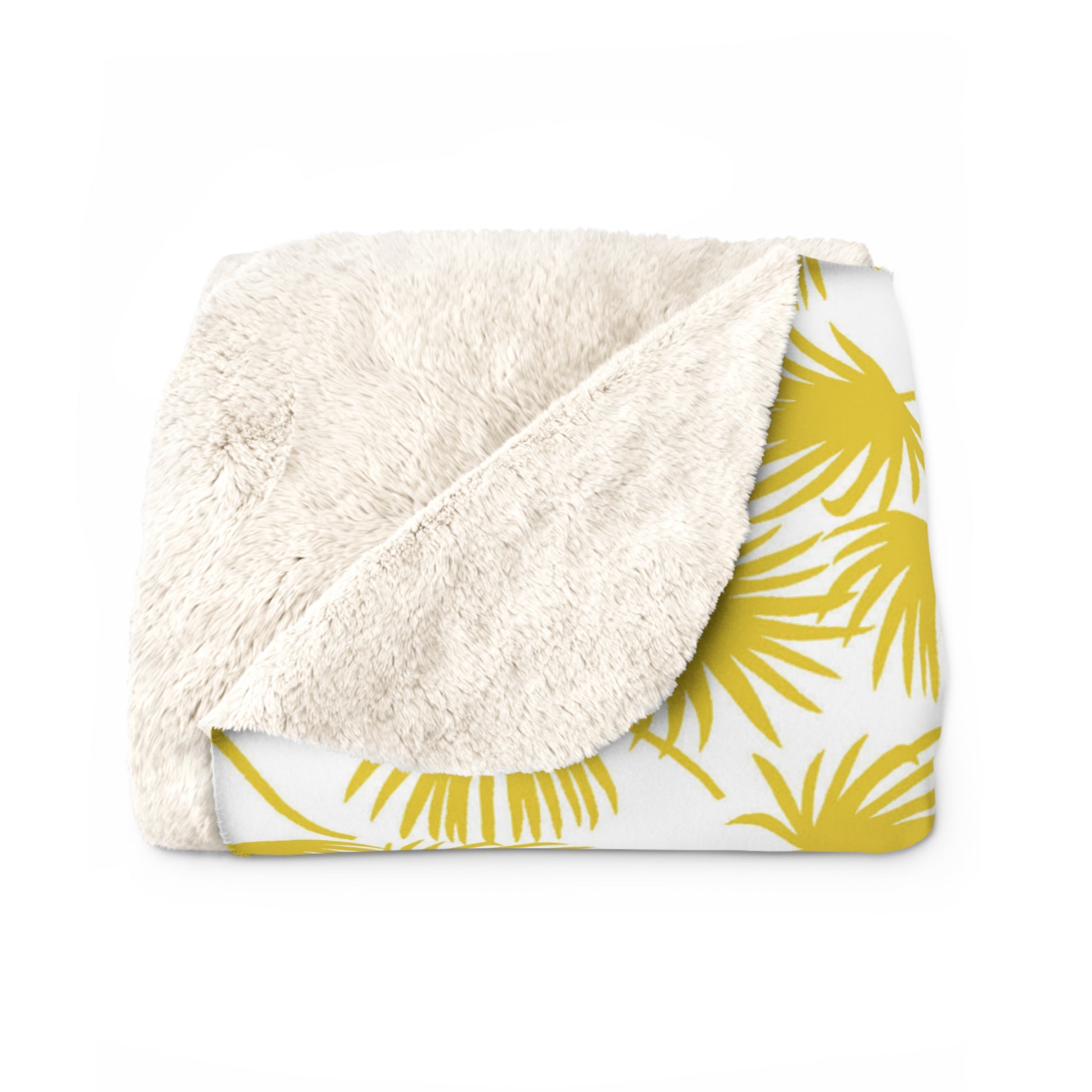 A folded throw blanket featuring a plush, cream sherpa fleece backside and a white front side printed with a yellow palm leaf pattern, shown on a plain white background.
