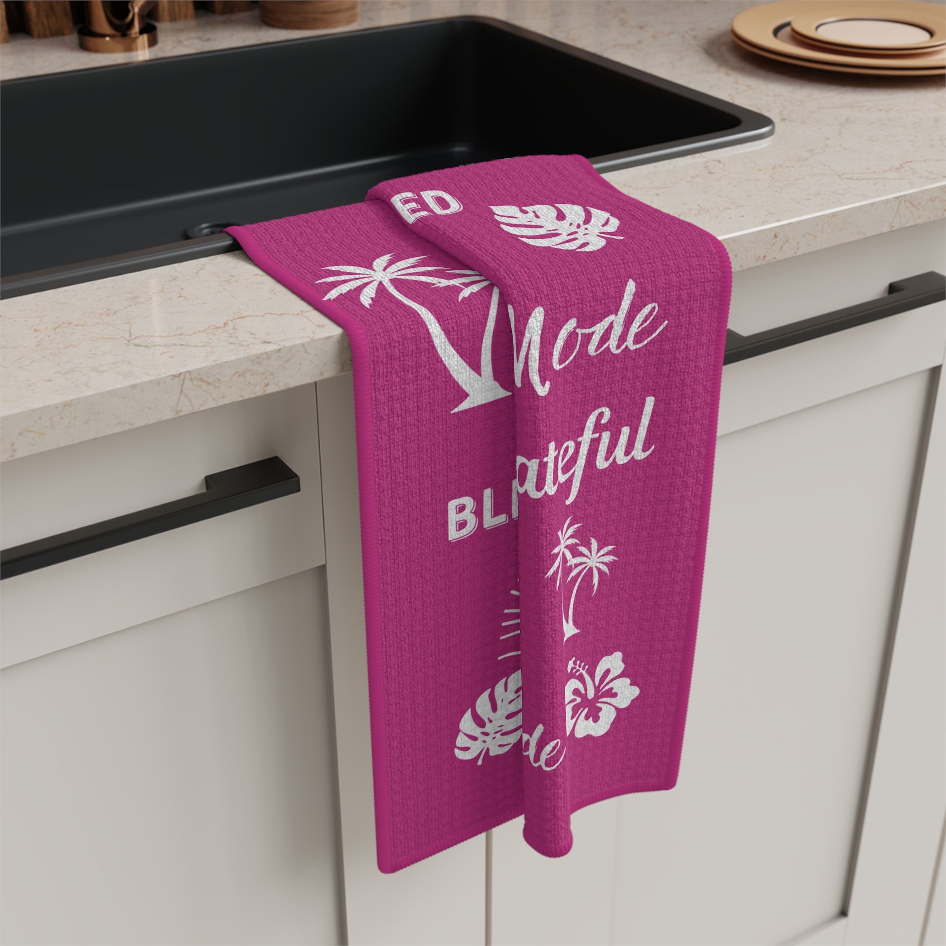 Raspberry Mahalo Mode kitchen towel with thankful grateful blessed and tropical island motifs hanging on sink