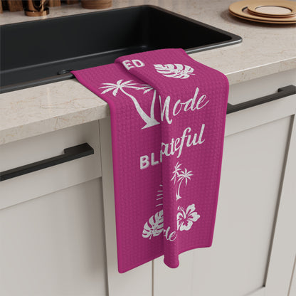 Raspberry Mahalo Mode kitchen towel with thankful grateful blessed and tropical island motifs hanging on sink