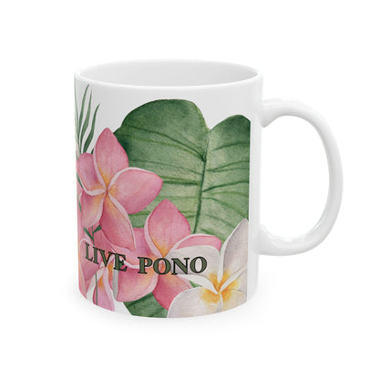 A white ceramic mug featuring a tropical watercolor design with pink plumeria flowers, green leaves, and the text 'LIVE PONO' printed on the front.