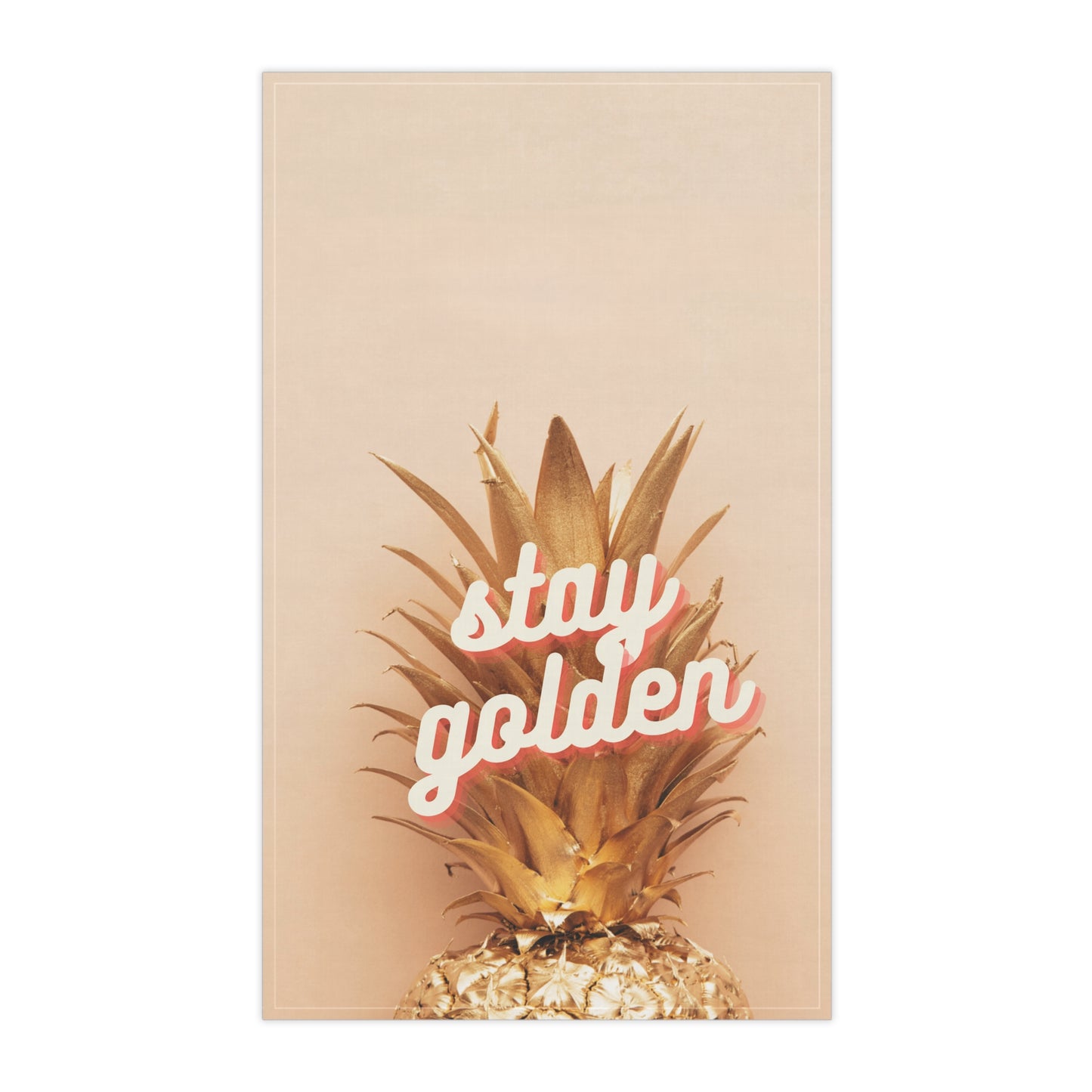 A tea towel featuring a golden pineapple on a warm beige background with the phrase 'stay golden' in white script outlined in pink, shown against a plain white backdrop.