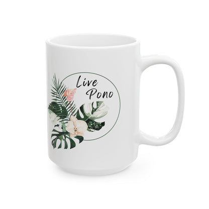 A white ceramic mug with a tropical leaf and flower illustration on the front, featuring the text 'Live Pono' in a circular frame.