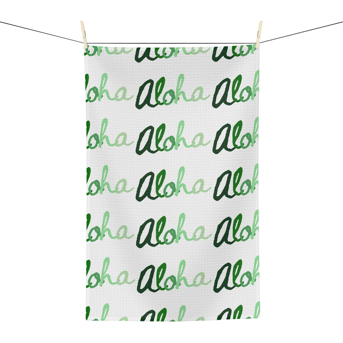 Green Aloha Hawaiʻi kitchen towel with repeating script design in light and dark green on white