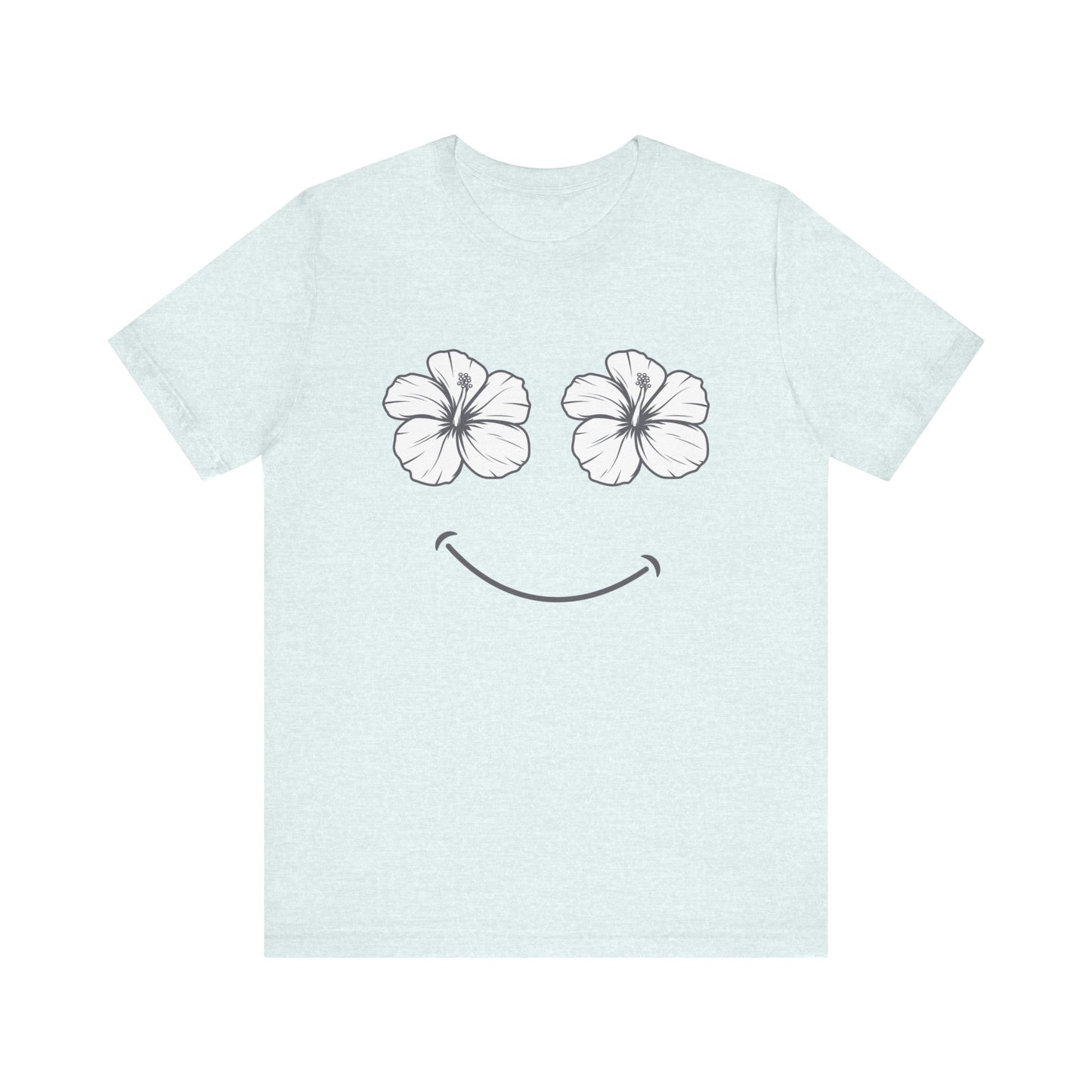 A light blue short-sleeve t-shirt with a graphic of two white hibiscus flowers forming eyes and a simple black smiley mouth on the front.