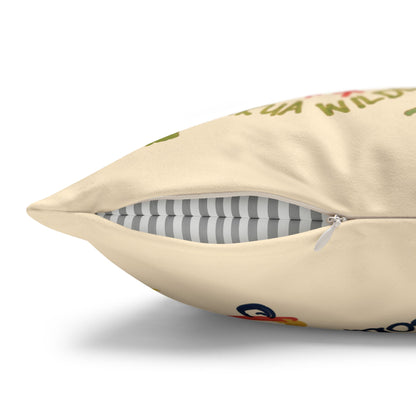A close-up of a cream-colored throw pillow with a partially unzipped front, showing a gray and white striped inner cushion. The cream fabric has a colorful, partially visible graphic print.