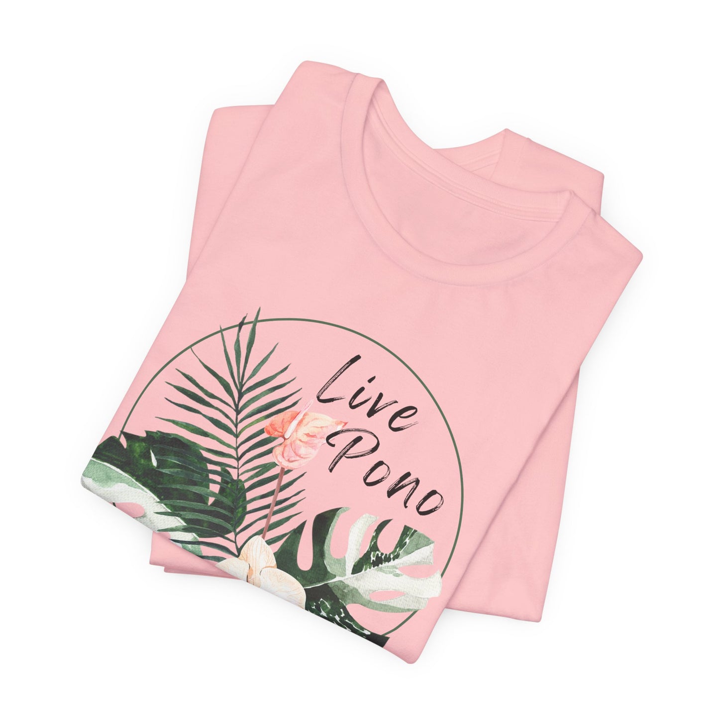 A folded light pink t-shirt with a tropical graphic print featuring palm leaves, a pink flower, and the text 'Live Pono' inside a thin circular outline, shown on a plain white background.
