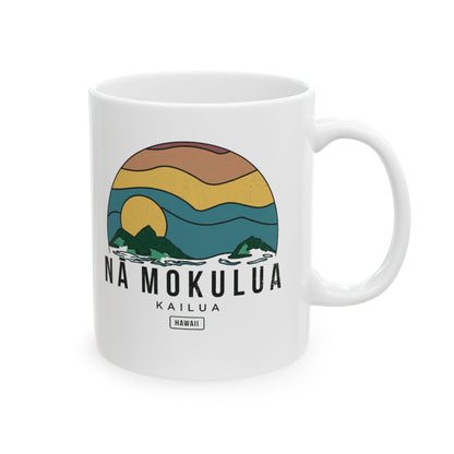 A white ceramic mug featuring a retro-style graphic of a sunset over ocean waves with the text 'NA MOKULUA KAILUA HAWAII' printed on the front.