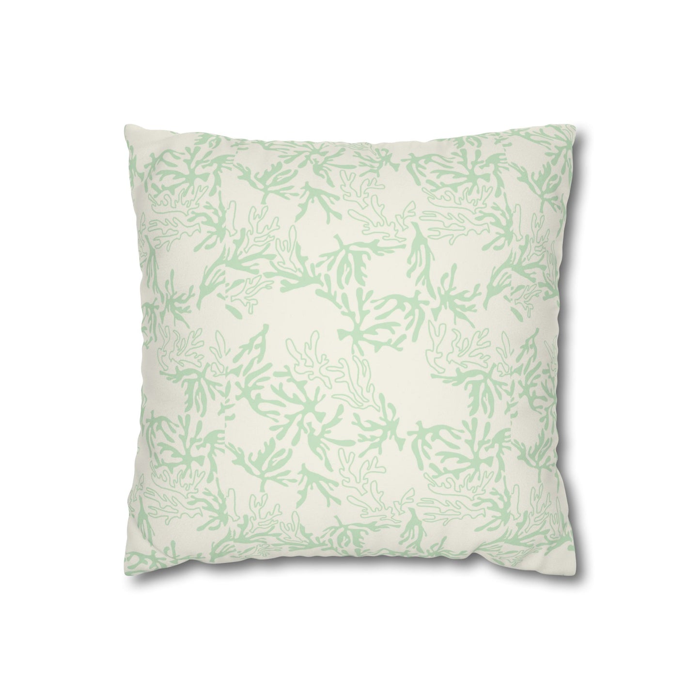 A square throw pillow with a light sage green coral pattern on an off-white background