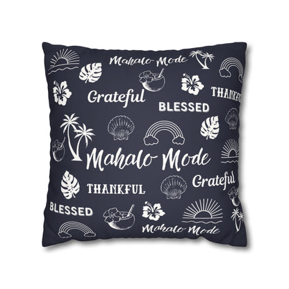 A square throw pillow in dark navy blue with a white tropical-themed print featuring palm trees, hibiscus flowers, seashells, sunsets, and words like 'Mahalo Mode,' 'Grateful,' and 'Blessed,' shown on a plain white background.
