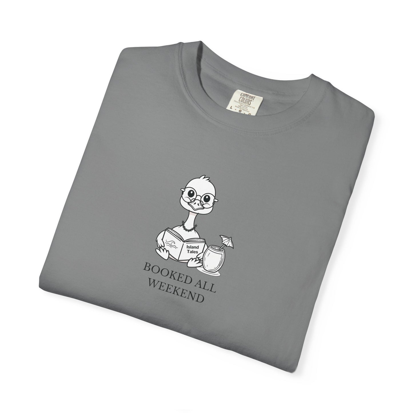 A grey comfort colors t-shirt with design of a nene goose reading a book and text 'booked all weekend' folded