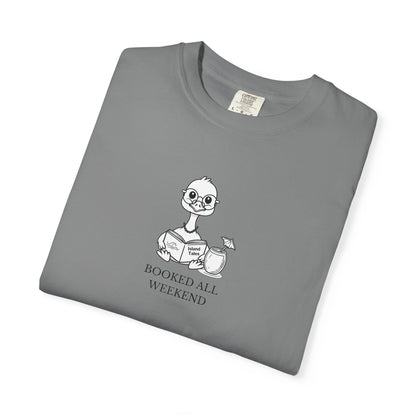 A grey comfort colors t-shirt with design of a nene goose reading a book and text 'booked all weekend' folded