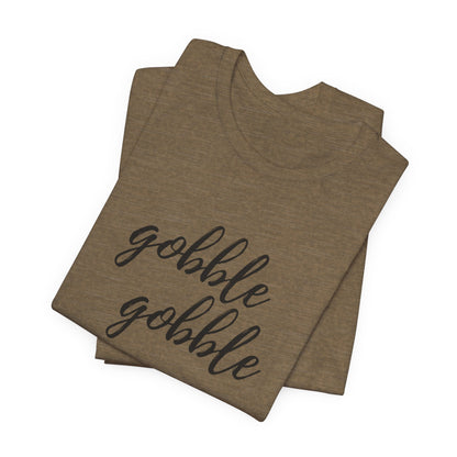 A folded heather olive t-shirt with the phrase 'gobble gobble' printed in black cursive script across the front, displayed on a clean white background.