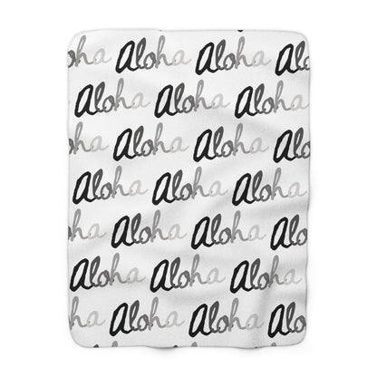 Aloha grayscale sherpa fleece blanket with a repeating black, white and gray island-inspired design.