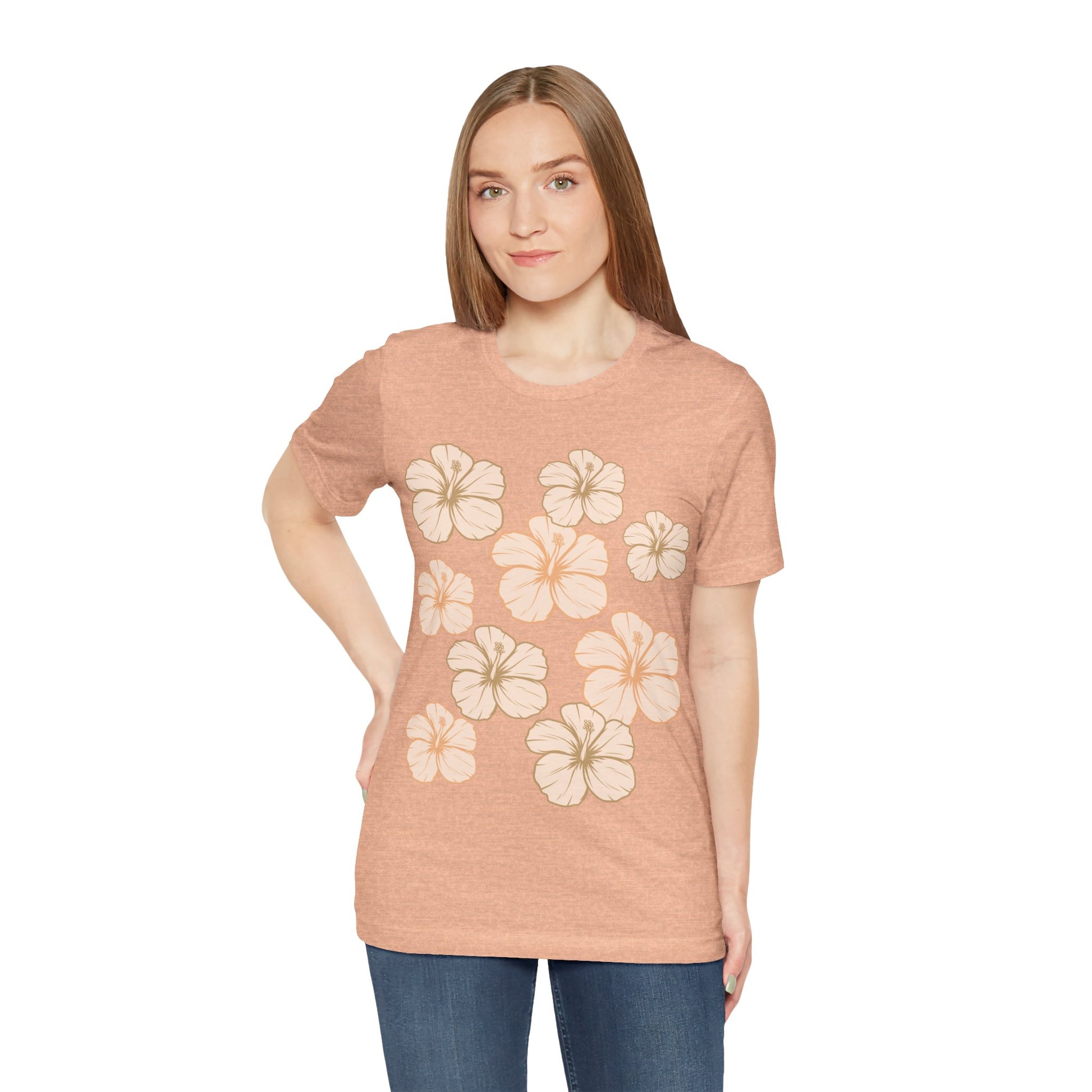 Woman wearing Hibiscus All Over Graphic Tee featuring scattered tropical hibiscus flowers on a soft unisex tee inspired by island life in Hawaii.