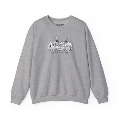 A gray crewneck sweatshirt featuring a black and white line art graphic of a couch with pineapples and the text 'couch cruisers' on the chest, displayed against a solid white background.