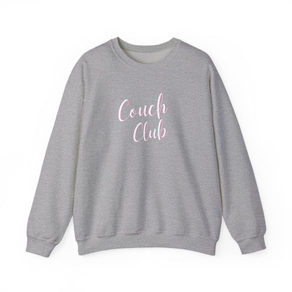 A heather gray crewneck sweatshirt featuring the words 'Couch Club' printed in a light pink cursive font on the chest, displayed against a solid white background.