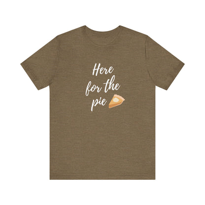 A heather olive short-sleeve t-shirt with a white script graphic reading 'Here for the pie' next to a small slice of pie illustration, displayed on a solid white background.