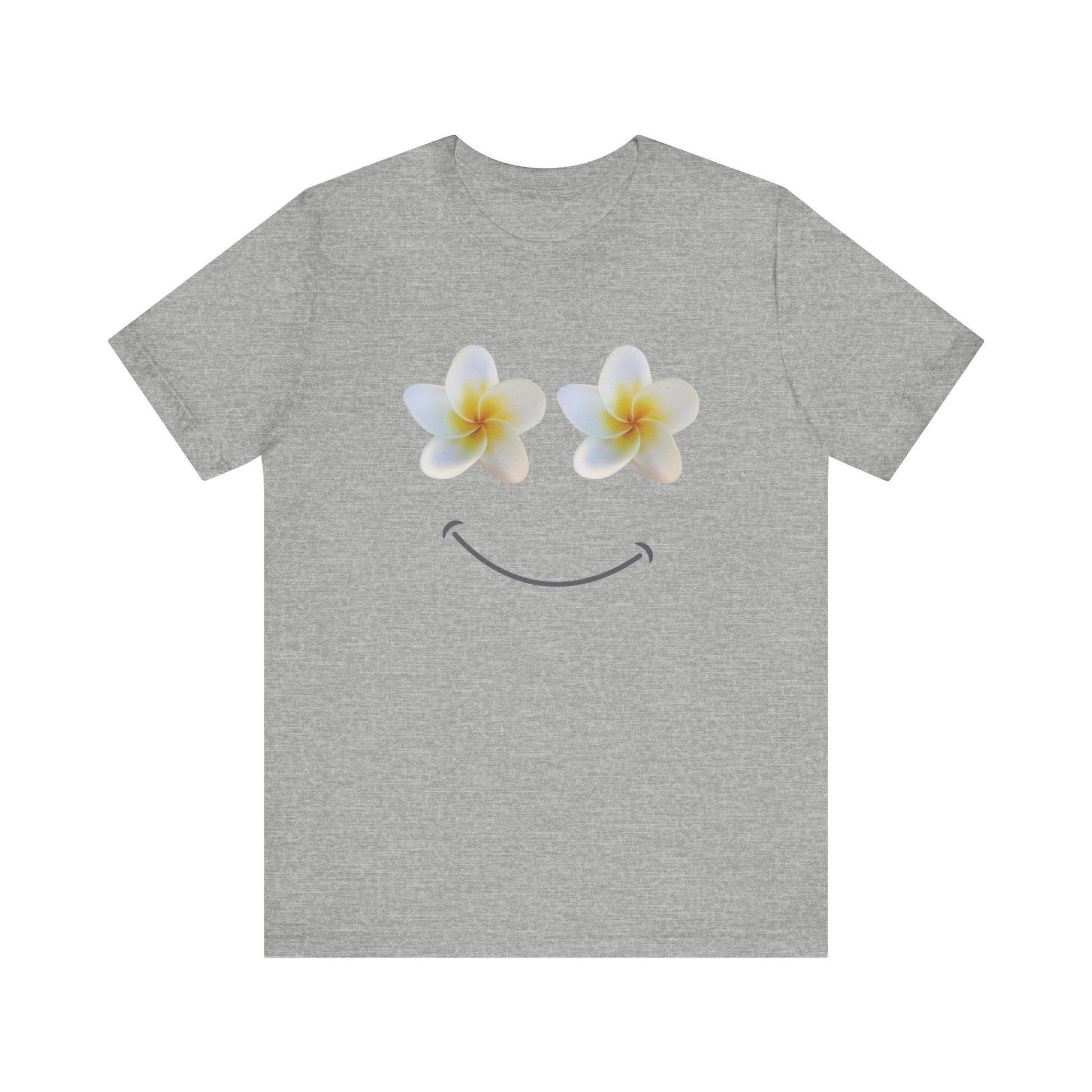 A heather gray short-sleeve t-shirt with a graphic of two white plumeria flowers forming eyes and a curved smile on the chest, displayed against a solid white background.