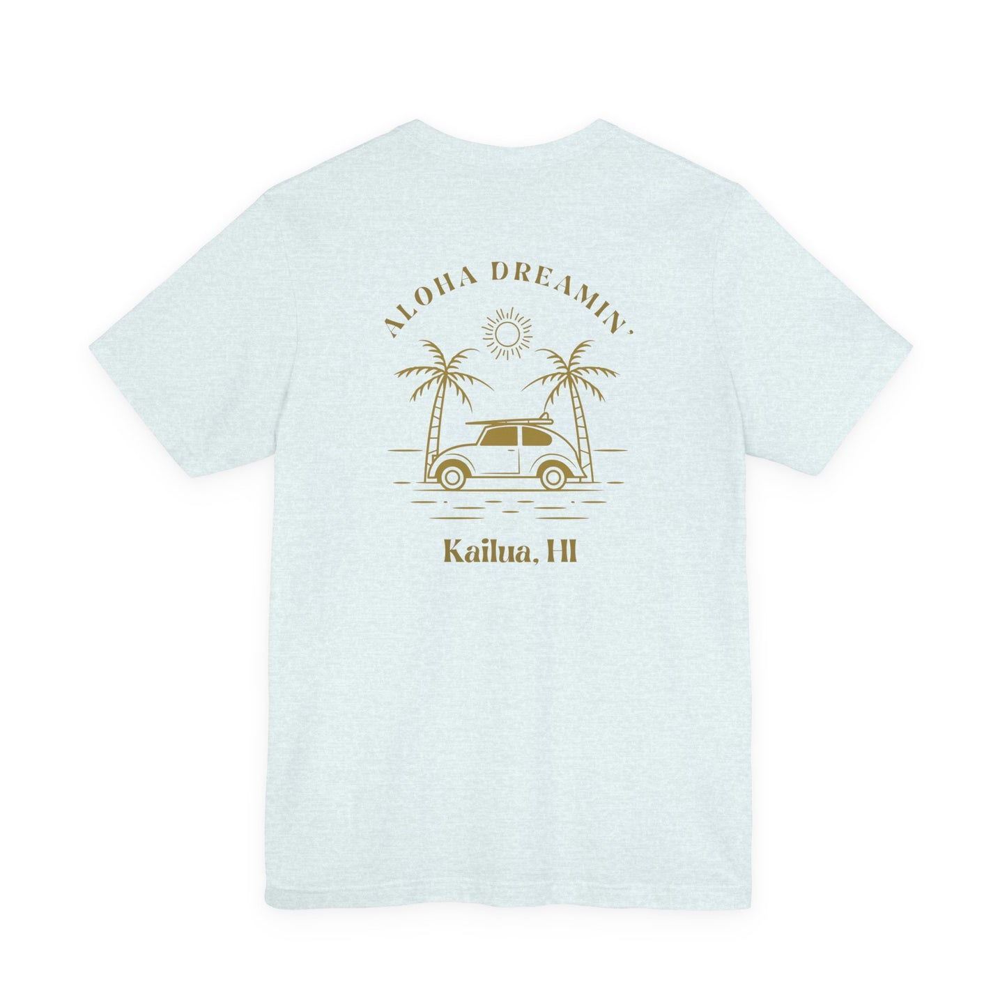 A light heather blue short-sleeve t-shirt shown from the back, featuring a retro-style tan graphic of a car between two palm trees with the text 'ALOHA DREAMIN'' and 'Kailua, HI'.