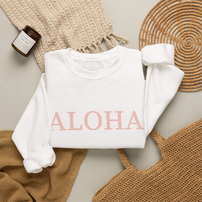 White sweatshirt folded with text 'ALOHA' in light pink