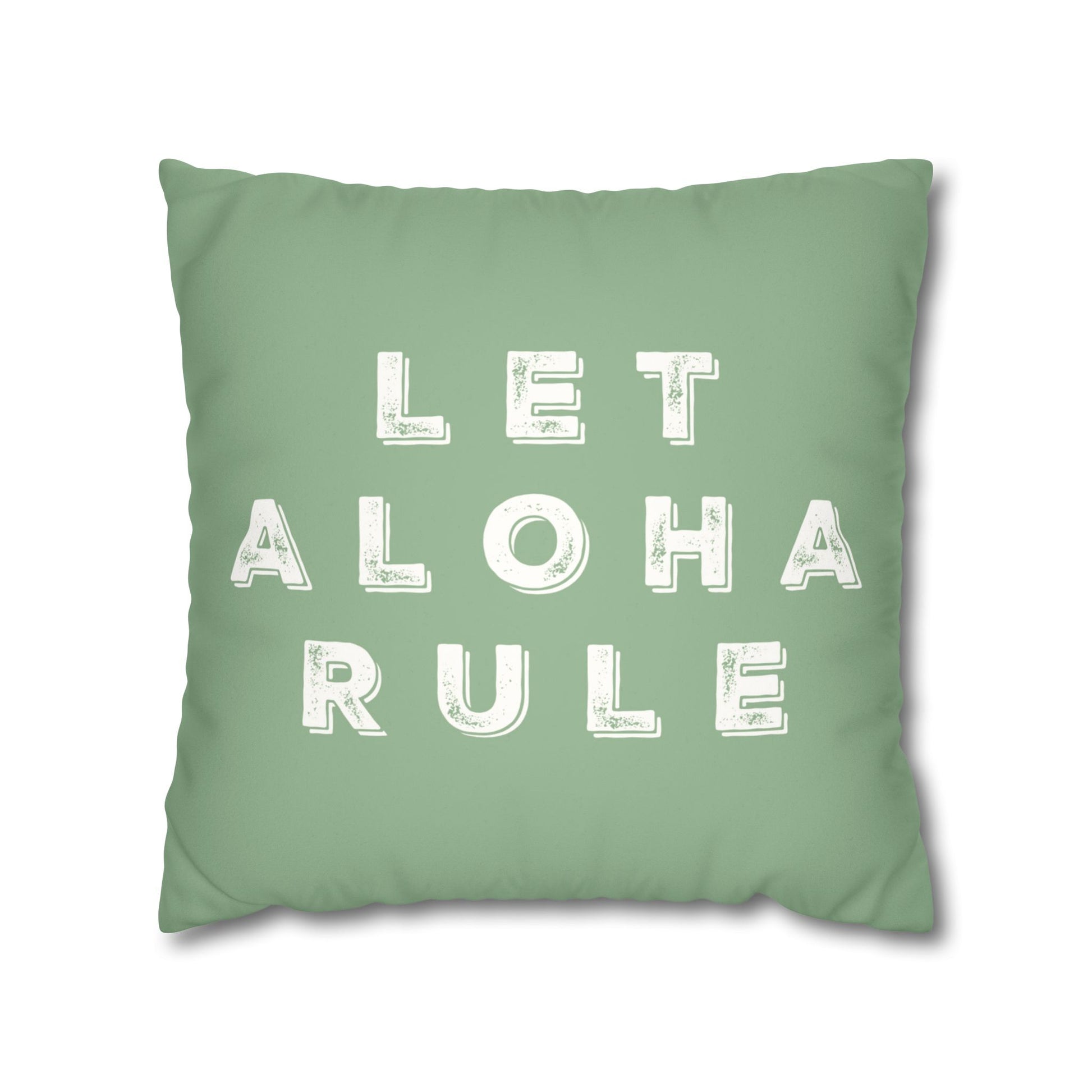 A square mint green throw pillow featuring the phrase 'LET ALOHA RULE' printed in distressed white block letters, shown against a plain white background.
