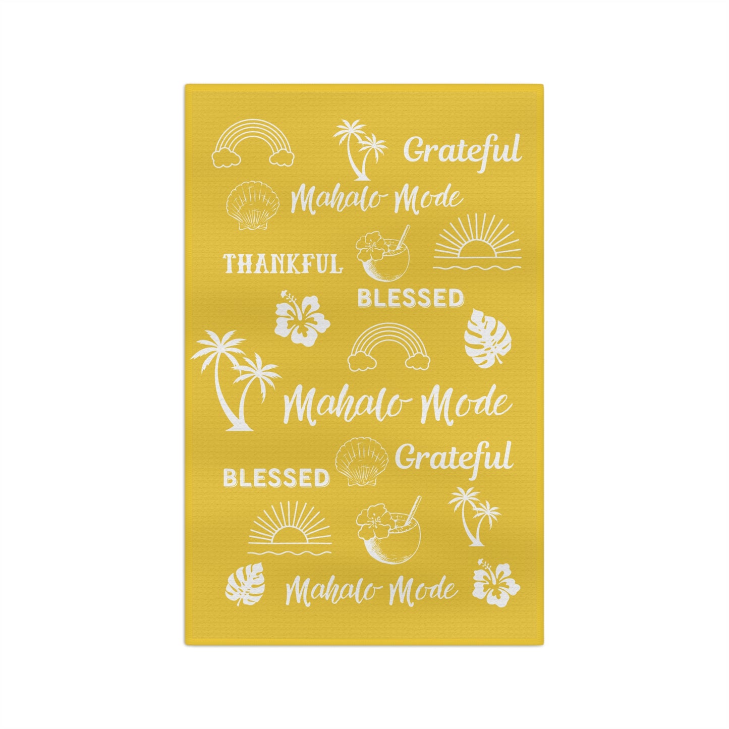 A yellow waffle-weave kitchen towel with white tropical-themed text 'mahalo mode' 'thankful' 'blessed' 'grateful' and illustrations, hanging from a clothesline with wooden clips against a white background.