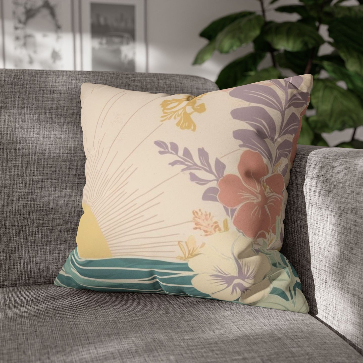 pastel sunrise wave faux suede pillow cover, featuring tropical florals and ocean-inspired artwork sitting on a grey couch in a tropical home