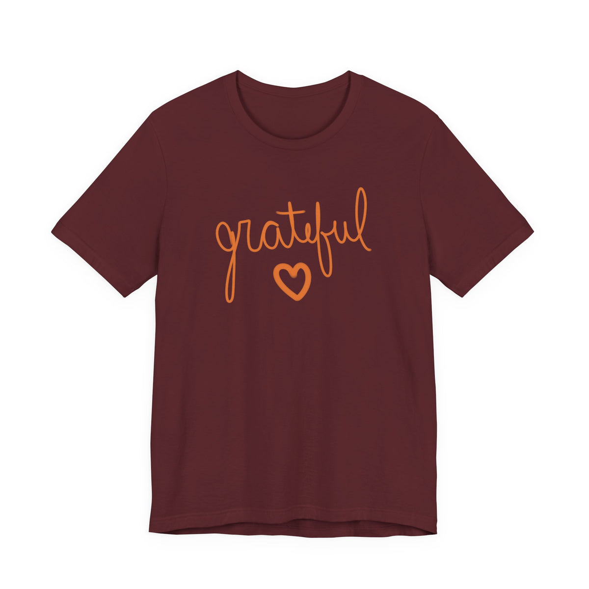 A short-sleeve crewneck t-shirt in maroon with the word 'grateful' written in orange cursive script and a matching orange heart underneath, shown on a plain white background.