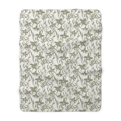 Sage green orchid-and-leaf print sherpa fleece blanket with a warm white background and rounded corners.