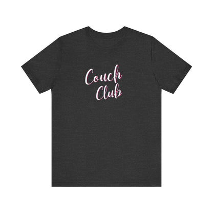 A dark heather gray crewneck t-shirt featuring the words 'Couch Club' printed in a pink cursive font across the chest, displayed on a solid white background.