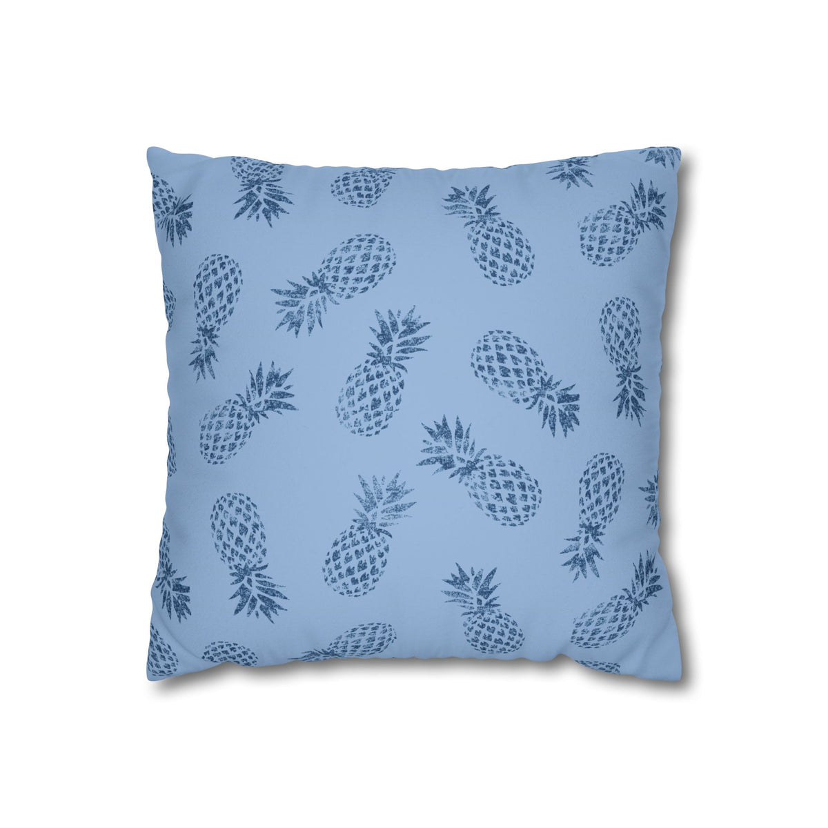 A square throw pillow featuring an all-over blue pineapple pattern on a light blue background, shown against a plain white studio backdrop.