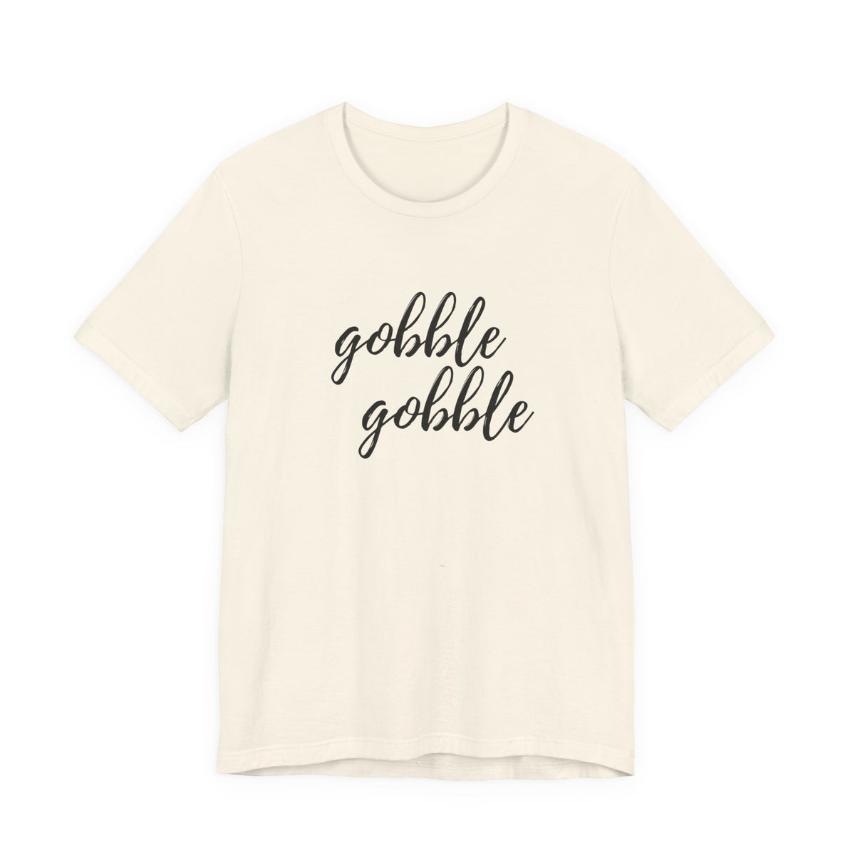 An off-white short-sleeve crewneck t-shirt featuring the phrase 'gobble gobble' printed in black cursive script across the chest, displayed against a solid white background.