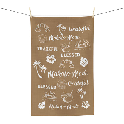 Tan Mahalo Mode kitchen towel with thankful grateful blessed and tropical island motifs