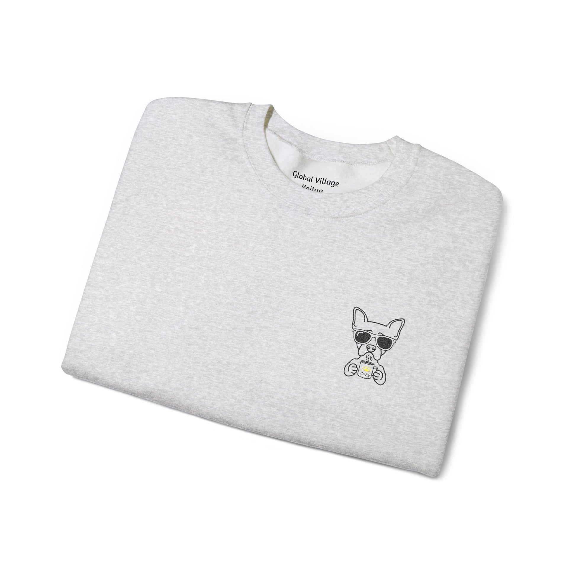 Folded grey sweatshirt with an embroidered dog drinking a cup of coffee on a white background