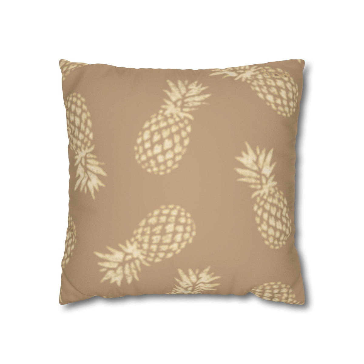 A square throw pillow featuring a repeating pineapple pattern in a light cream color on a warm tan background, shown against a plain white background.