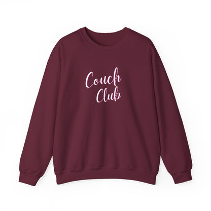 A maroon crewneck sweatshirt featuring the words 'Couch Club' printed in a light pink cursive font on the chest, displayed against a solid white background.