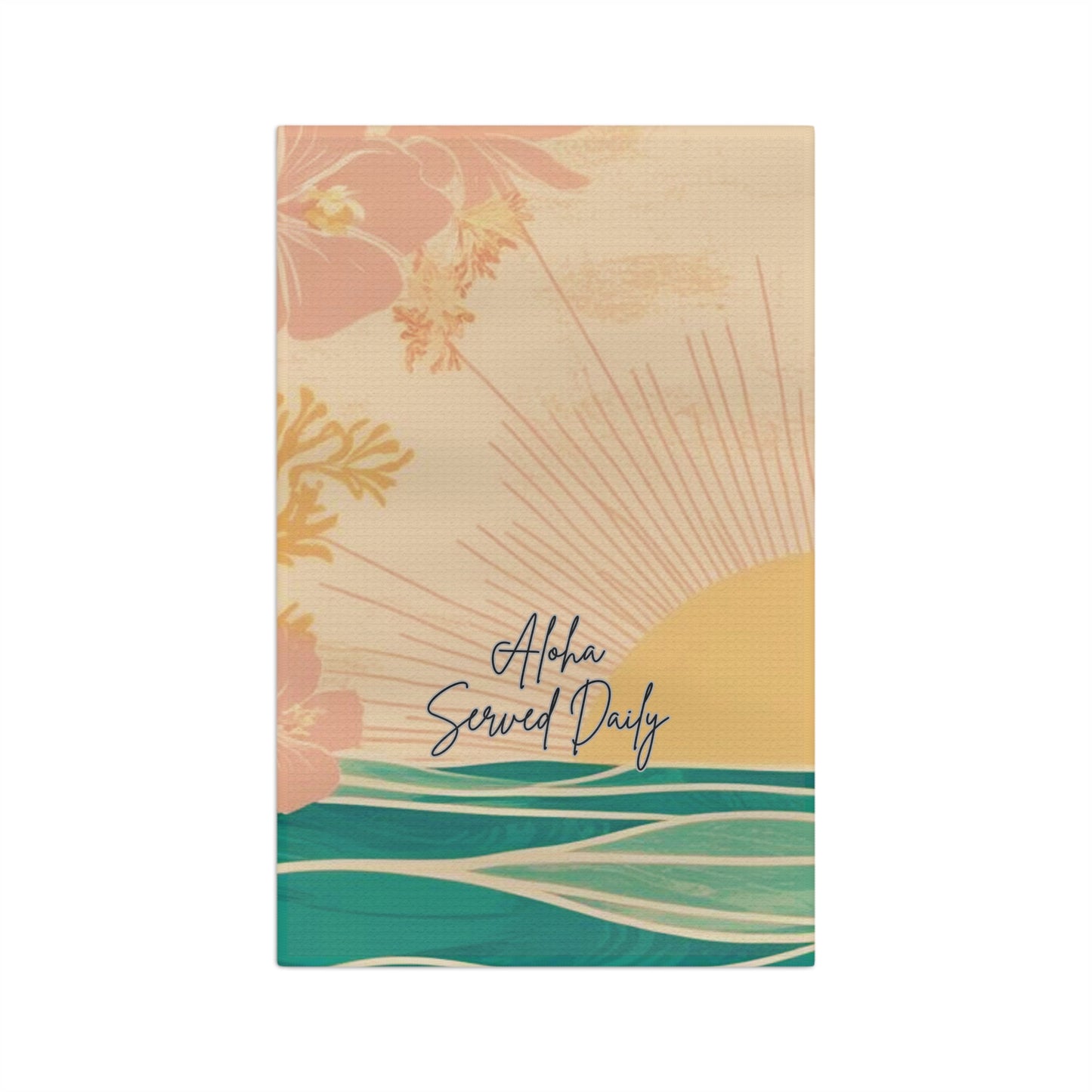 A rectangular kitchen towel featuring a tropical sunset design with pink flowers, a yellow sun, teal ocean waves, and the text 'Aloha Served Daily' on a cream background.