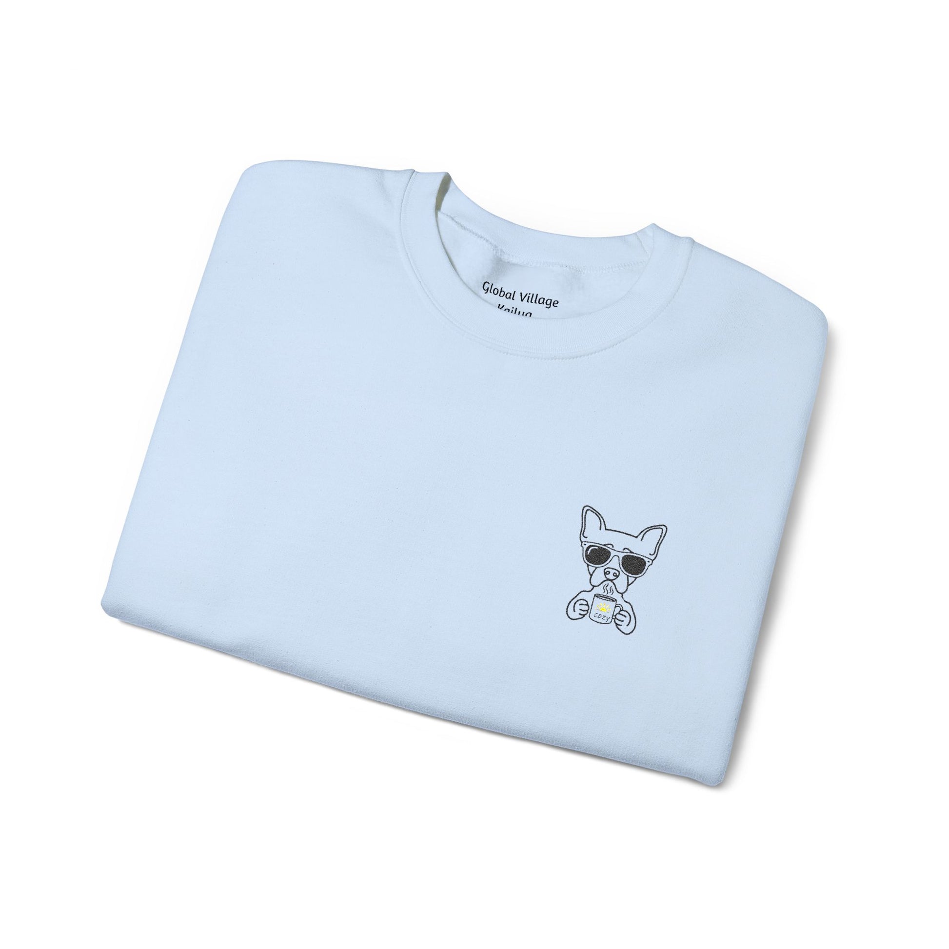 A light blue folded crewneck sweatshirt with a small graphic of a cartoon dog wearing sunglasses on the left chest, displayed on a clean white background.