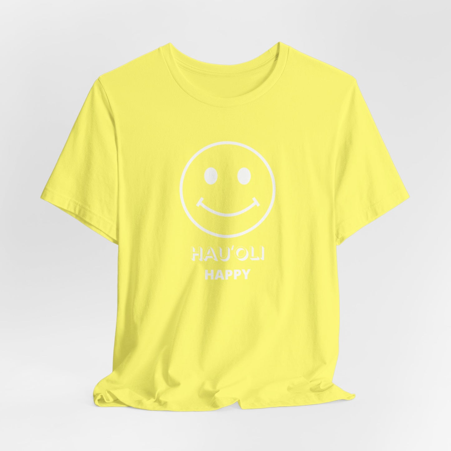 A bright yellow short-sleeve t-shirt with a white minimalist smiley face graphic and the words 'HAU'Oli HAPPY' printed on the front, displayed against a light gray background.